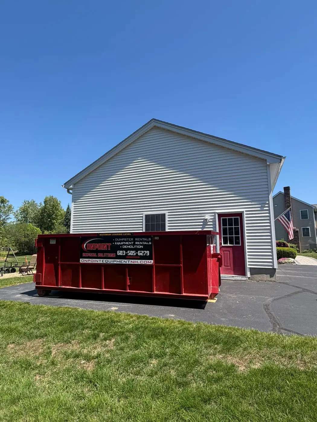 15 yard Onpoint roll off dumpster placed on a driveway beside a New Hampshire home